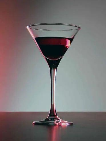 Blood red cocktail in a martini glass