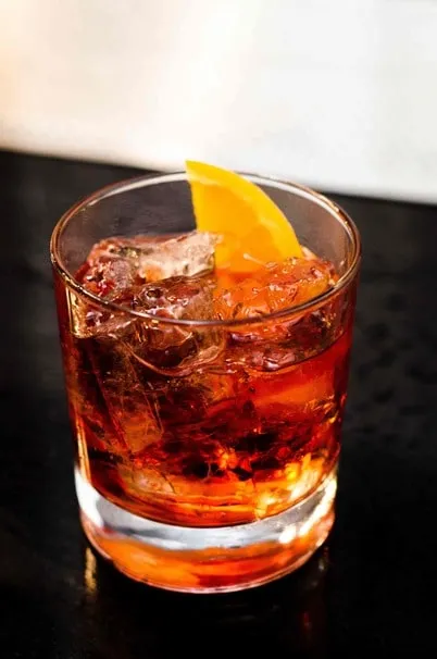 Orange cocktail in a rocks glass with orange peel