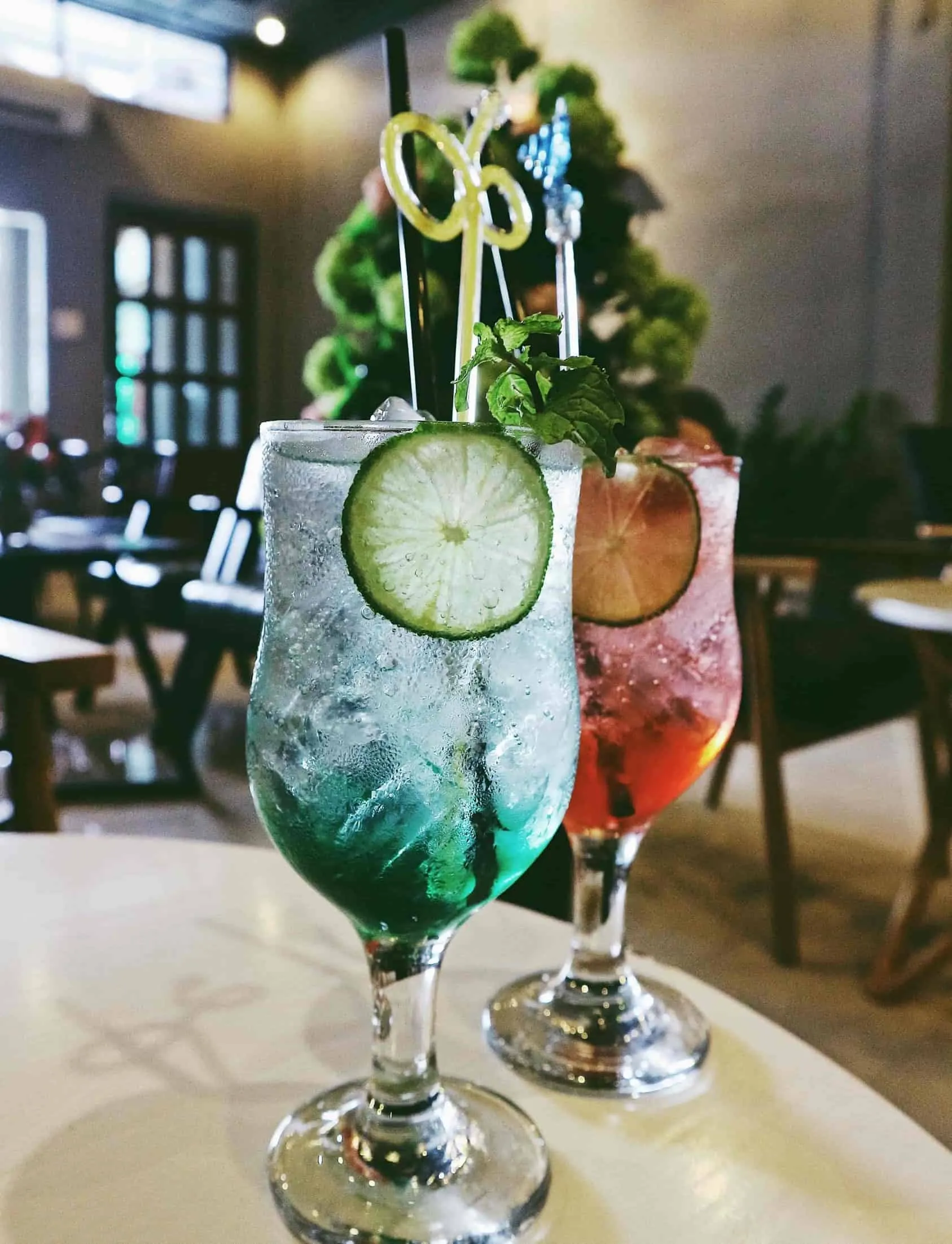 Two cocktails on a bar table